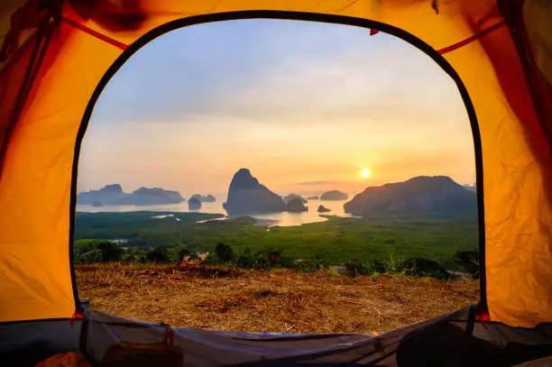 Photo of Samed Nangchee viewpoint looking through tent in sunrise time, Phangnga, Thailand