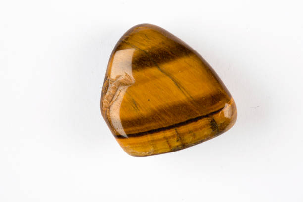 Tiger's eye, close-up of a precious stone with white background, collectibles