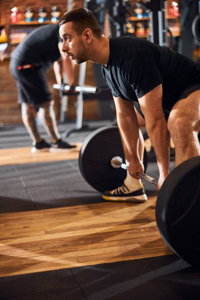 istock Young bodybuilder practising weight-lifting at the gym 1310613593
