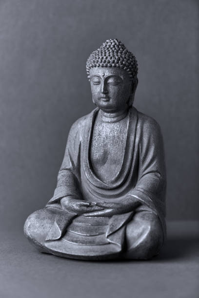 istock Meditating Buddha Statue on paper background. Close up. 1310614693