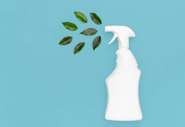 istock White bottle with a spray bottle and green leaves 1310615635