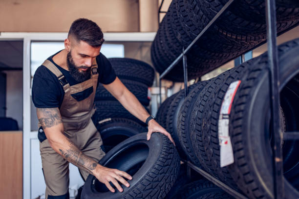 istock Young repairman changing tires in garage 1310615931