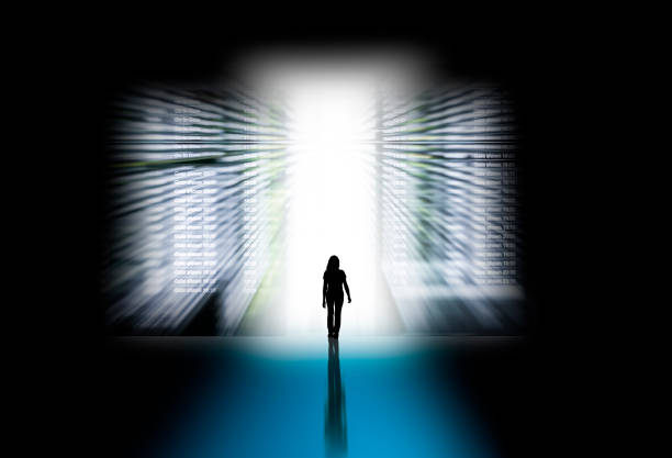 Silhouette of a woman through a bright keyhole