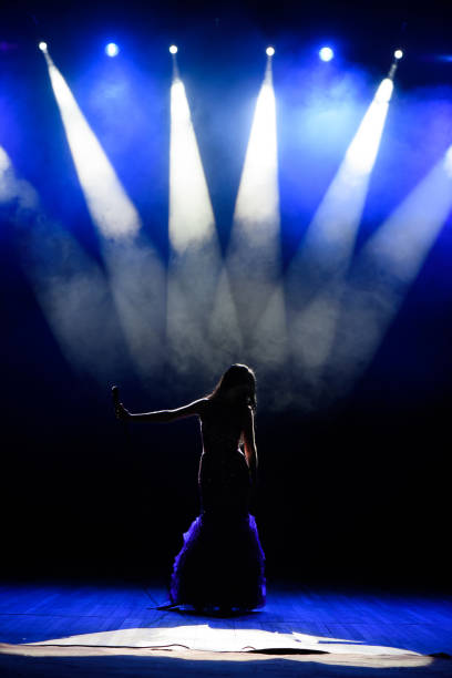 istock A young woman singer on stage during a concert. 1310625089