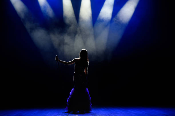 istock A young woman singer on stage during a concert. 1310625095
