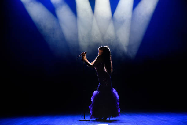istock A young woman singer on stage during a concert. 1310625105