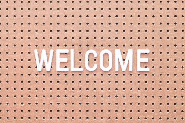 istock Word Welcome made from white letters on brown pegboard, horizontal 1310626657