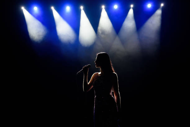 istock Female singer on the stage holding a microphone. 1310628215