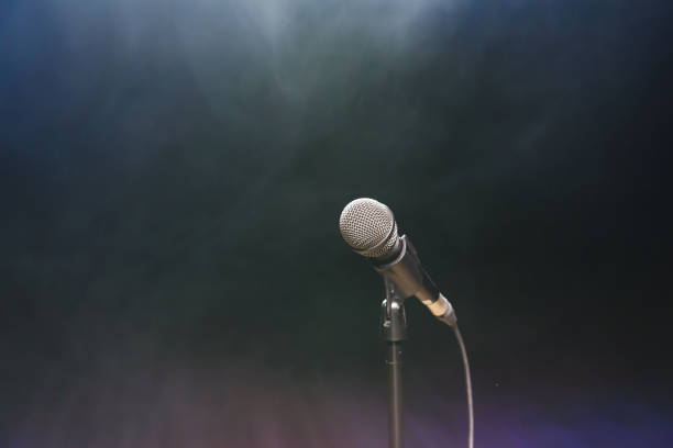 istock Live music background. Microphone and stage lights. Sing and karaoke. 1310628946