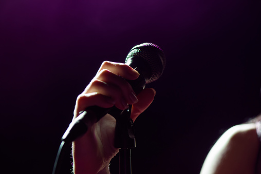 Microphone in hand singer on stage