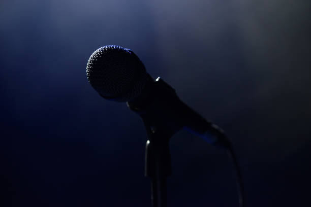 istock Live music background. Microphone and stage lights. Sing and karaoke. 1310629075