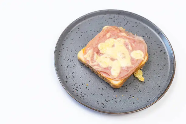 Photo of Baked Sandwiches with ham and cheese served on the plate