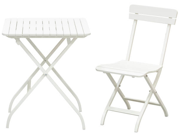 White garden folding chairs and folding table in front of white background White garden folding chairs and folding table in front of white background folding chair stock pictures, royalty-free photos & images