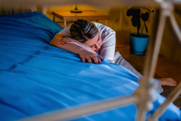 istock Depressed woman sitting on the floor 1310640412