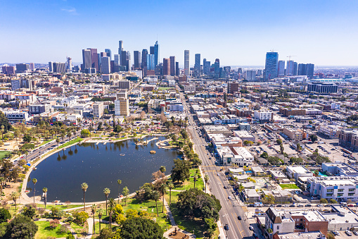 A panoramic view of downtown Los Angeles skyline behind beautiful MacArthur Park