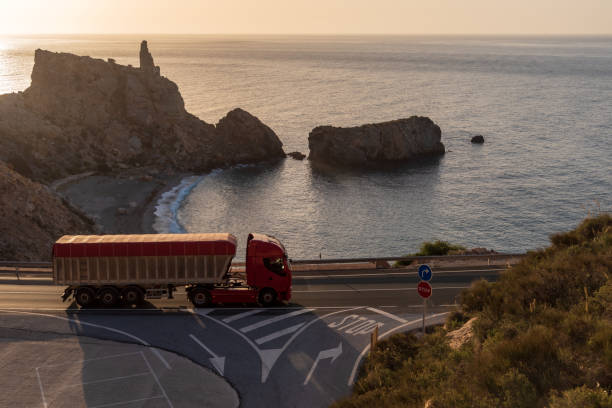 istock Tipper truck driving on a mountain road 1310641808