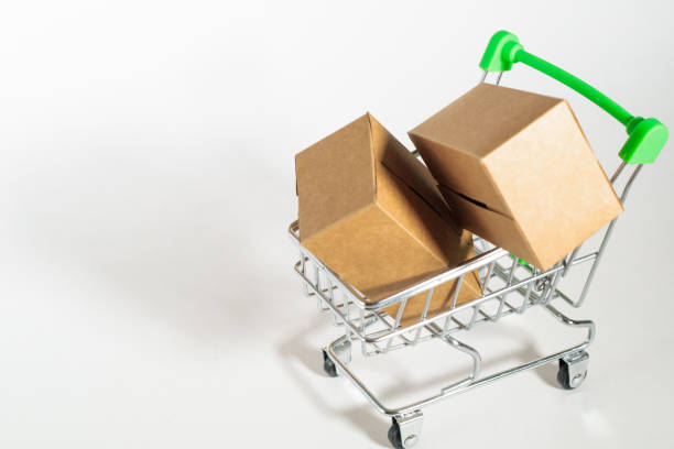 istock Shopping trolley with paper brown carton boxes 1310643559