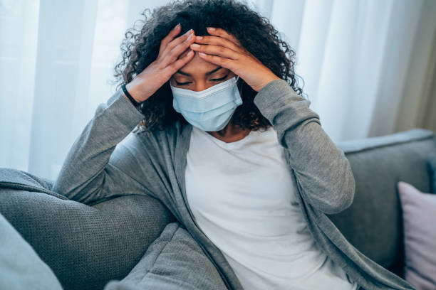 istock Woman is having a headache at home during pandemic. 1310644538