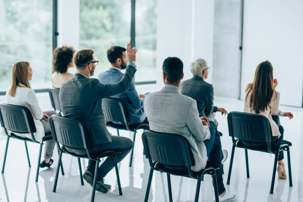 istock Back view of business persons having a training class in a board room. 1310644598