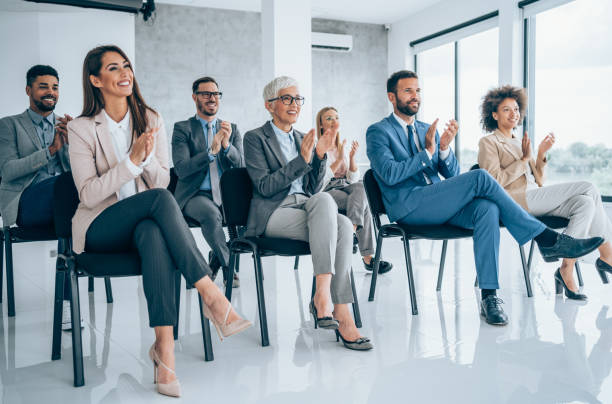 istock Businesspeople applauding during a seminar in conference hall. 1310644673