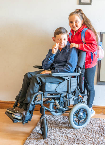 istock Young carer with boy in wheelchair 1310644929