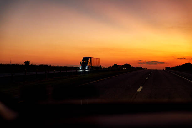 istock Dramatic Sunset Sky Expressway Semi Tractor Trailer Truck 1310645530