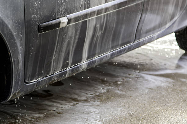 istock Washing car with hose 1310645679