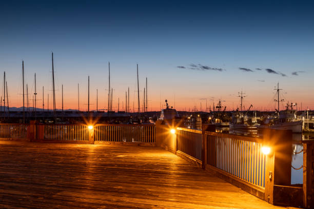 Lights on the Public Pier as the Sunset over Port Gardner Marina in Everett Washington Sunset over Port Gardner Everett Washington everett washington state stock pictures, royalty-free photos & images