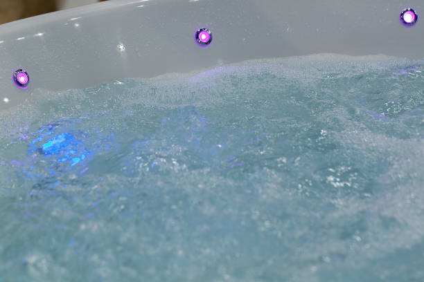 istock bubbling clear water in a hot tub with colored lights 1310649549
