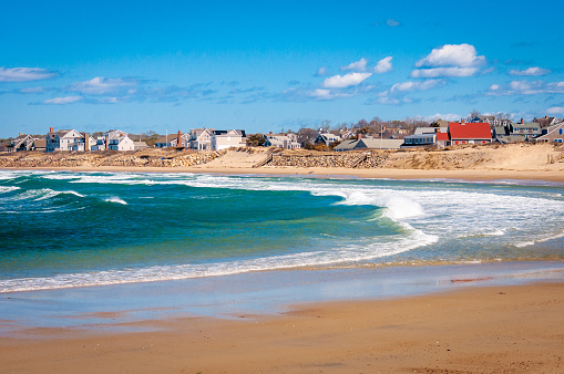 March waves come ashore at Corporation Beach in Dennis, Massachusetts as large beach fronrt homes, mostly closed for the winter await the return of their owners when warmer weather arrives.