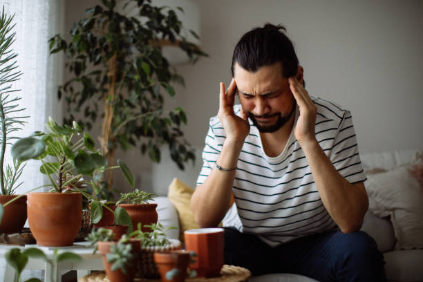 istock Man holding coffee cup while looking away at home 1310650505