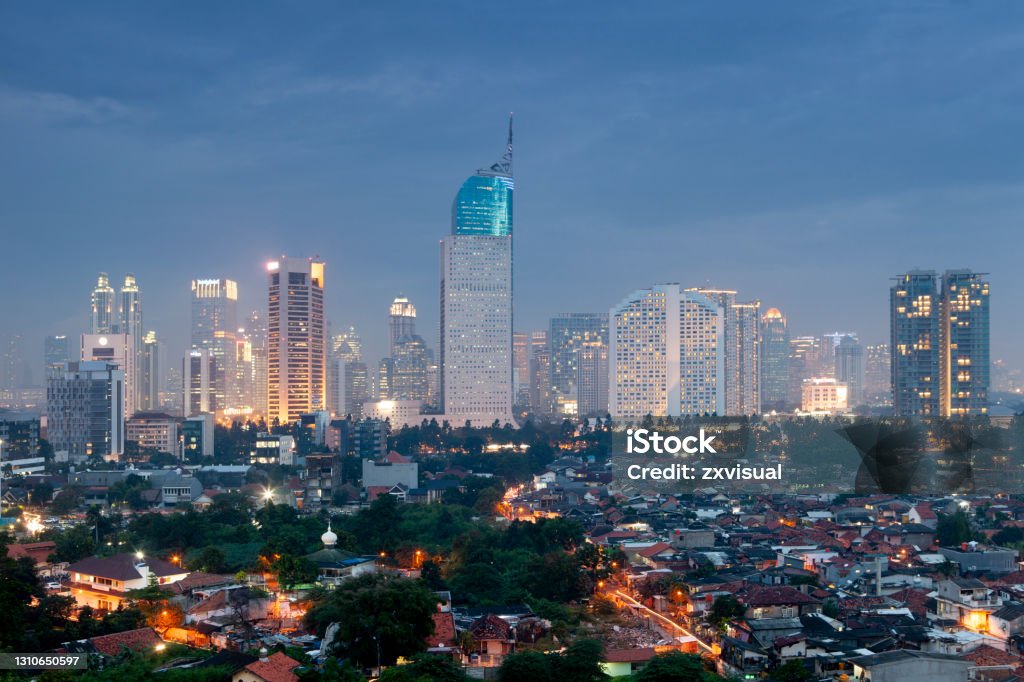 Jakarta Skyline View of the city skyline illuminated at dusk in Jakarta, Indonesia. Jakarta Stock Photo