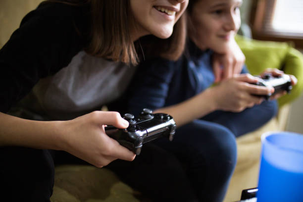 istock Brother and older sister playing video games 1310650960