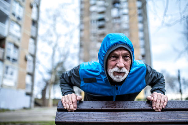 istock Senior man doing push-ups on cold rainy day. 1310652594