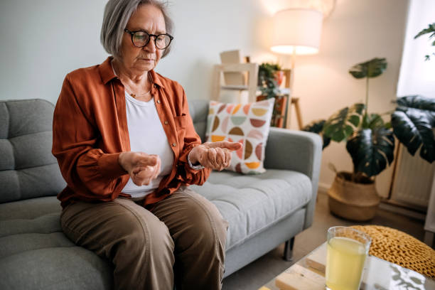 Senior woman Senior woman taking care of her health rheumatoid arthritis stock pictures, royalty-free photos & images