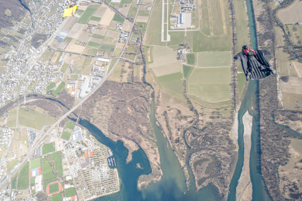 istock Wingsuit fliers soar above Swiss mountain landscape 1310658025