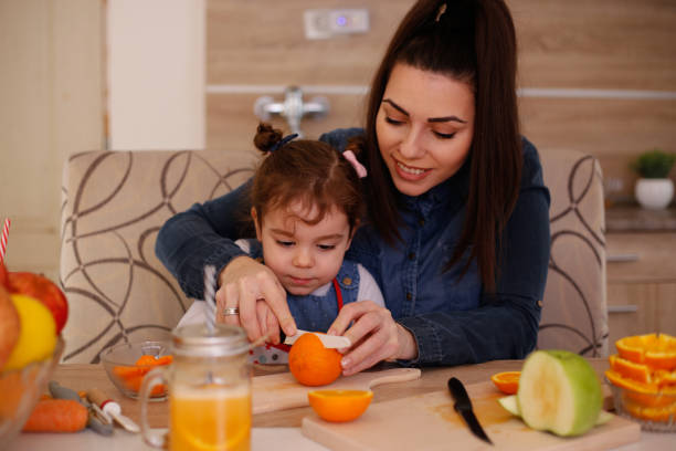 istock Mother and daughter having fun with fruit. Stock photo 1310660310