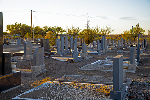 Rural cemetery outside small town with many head stones in early morning in Northern Cape, South Africa