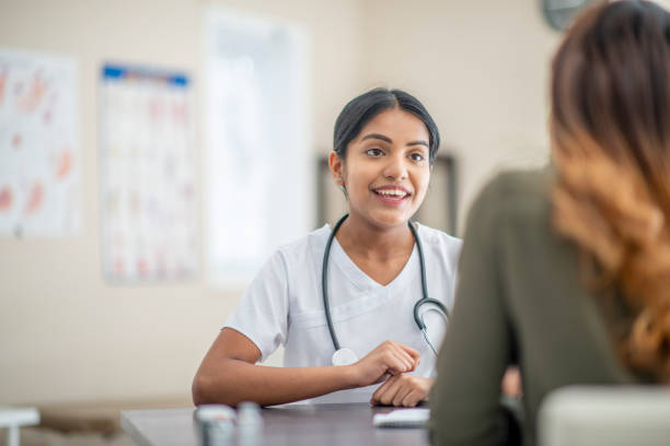 istock Smiling Female Indian Nurse With A Patient 1310664423