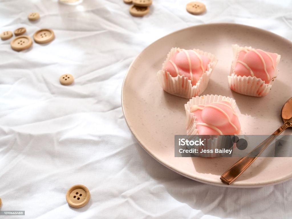 Pink Cakes Pink cakes on a white bright cloth Afternoon Tea Stock Photo