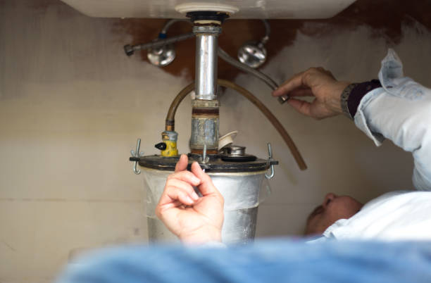 istock Plumber Lying on Floor with Head Under Sink 1310669214