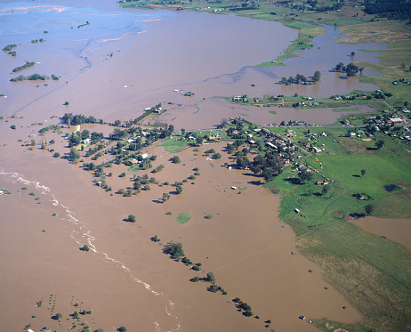 flood waters from the Hawkesbury river surround farm houses and crops near Windsor , Sydney Australia in 1986.
