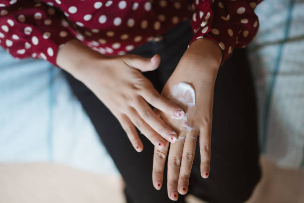 istock Young woman applying moisturizer on her hands. 1310689427