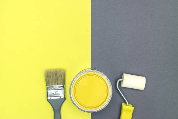 istock decorating or renovations concept. painting tools with can on yellow and gray background 1310691988