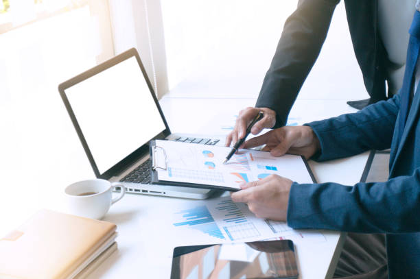 Man using, working on laptop with blank screen in meeting room.