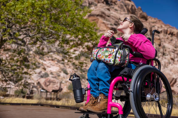 Woman With Disability Exploring A woman in a wheelchair with a disability exploring disabled person hiking outdoors stock pictures, royalty-free photos & images