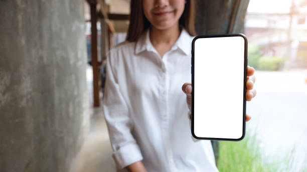 istock a beautiful woman showing a mobile phone with blank white screen 1310694907