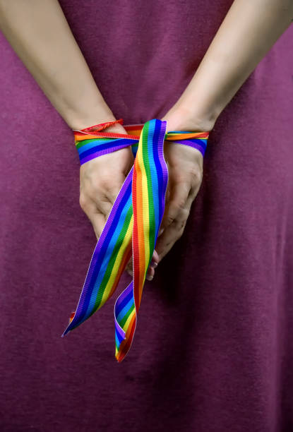 istock Hands tied with rainbow ribbon - lgbt symbol 1310698254