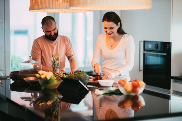 istock Young couple cooking together in the kitchen at home 1310700193