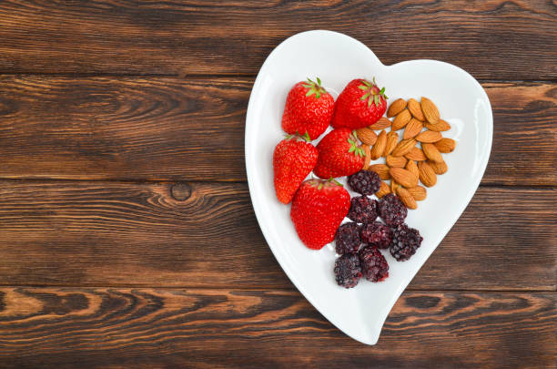istock fruit, nuts and berry in ceramic shaped heart plate 1310700371